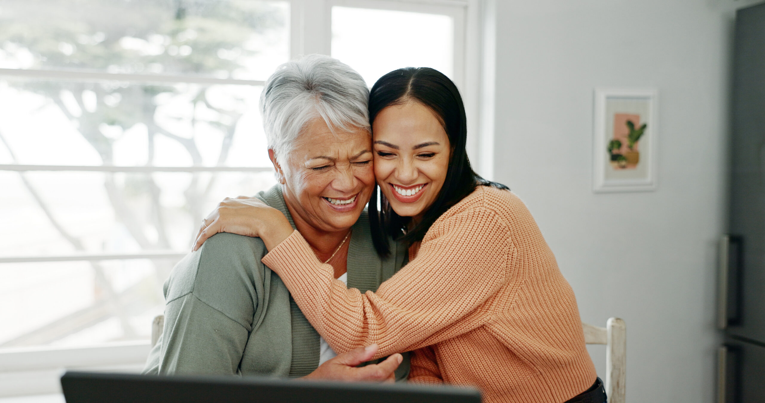 A daughter hugs her aging mother.