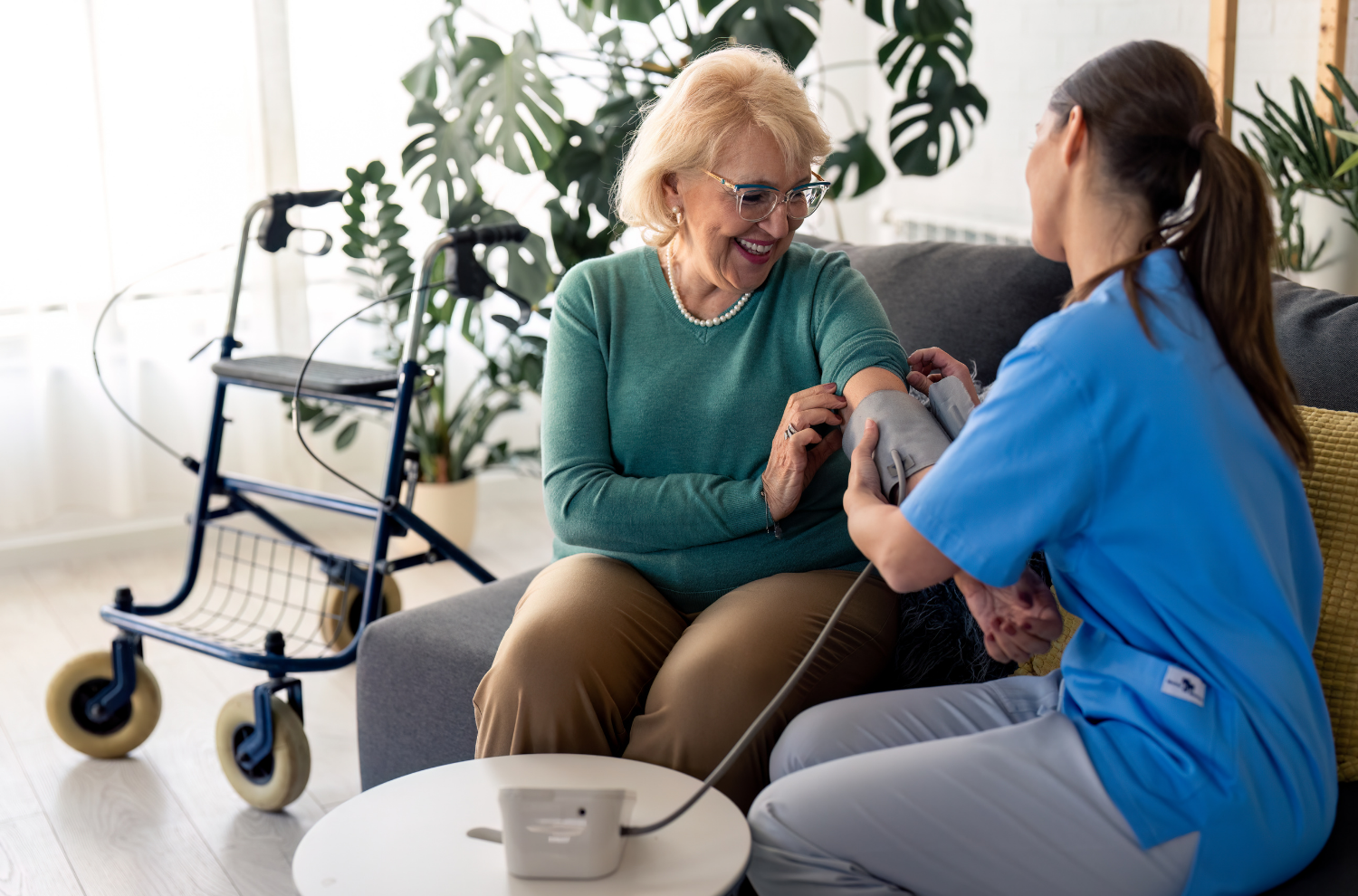 A nurse takes an elderly woman's blood pressure.